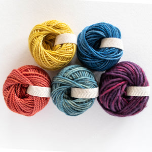 five mini cakes of naturally dyed yarn