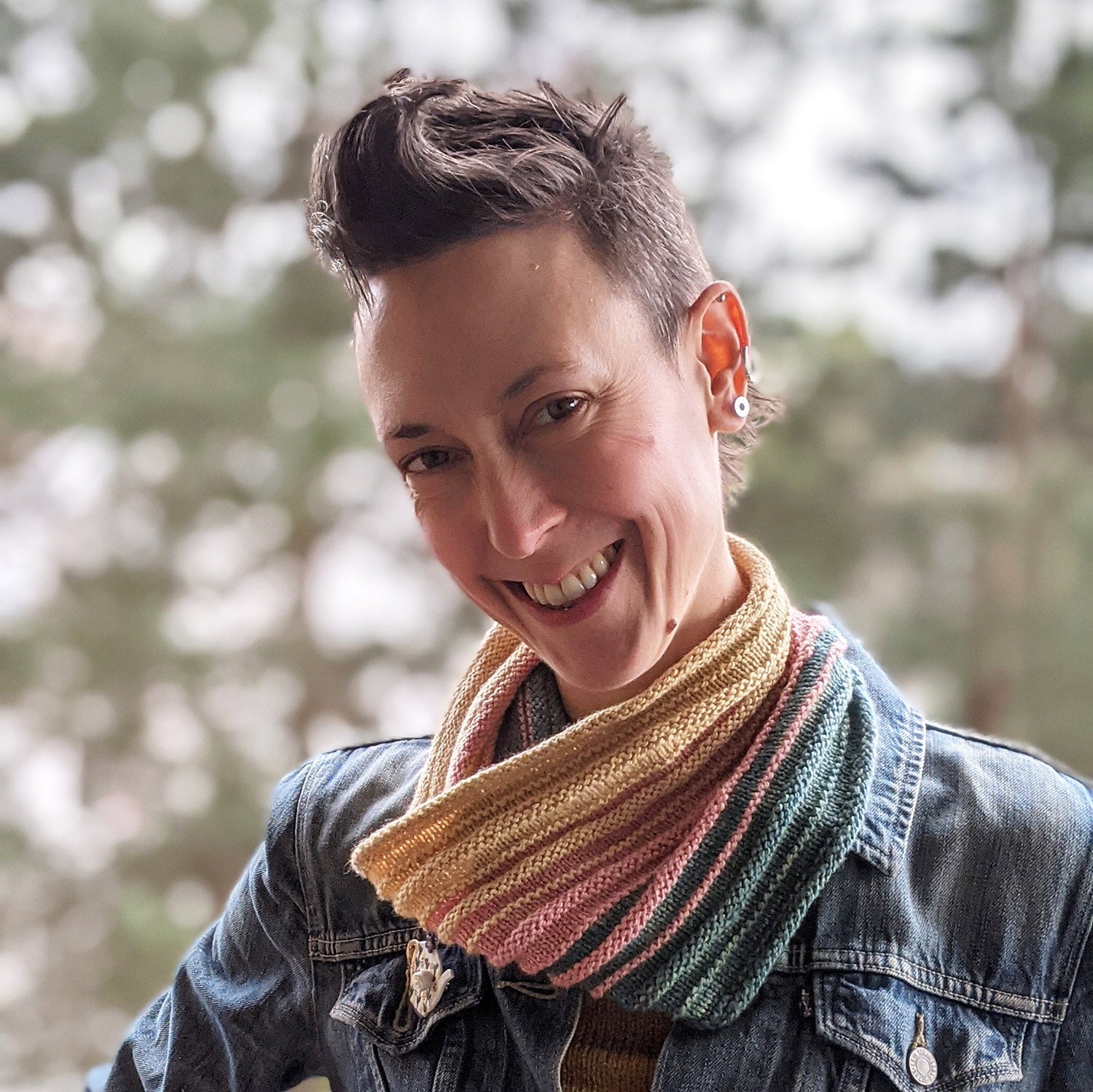 Person wearing Cupid cowl with out of focus trees in the background