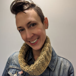 Person smiling wearing a bulky weight cowl which has been folded in half