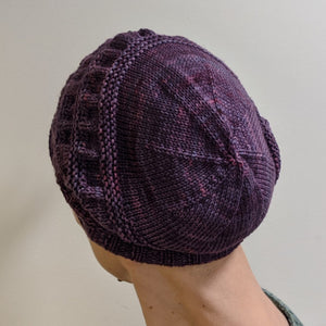 The back of a persons head showing the spiral design of the decreases on the Swoogie hat