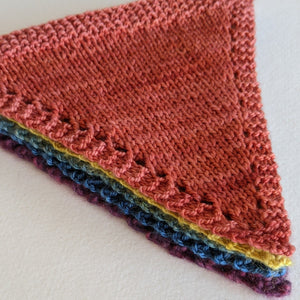 Stack of five hand knitted bunting hand dyed with natural dyes
