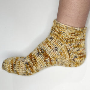 Hand knitted sock on a foot in TigerStar - Naturally dyed yarn from Canada