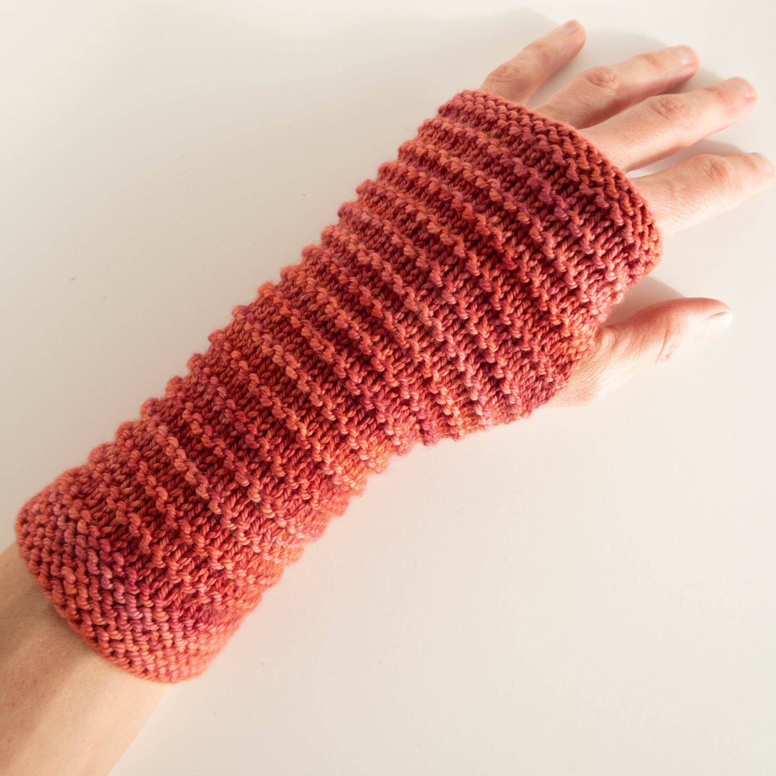 Hand wearing a wristwarmer