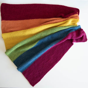 Naturally dyed baby blanket in colours of the rainbow concertinaed 